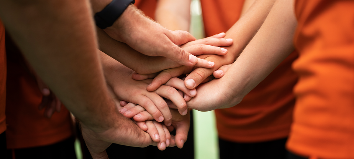 verschillende teamleden van een sportclub houden de handen bij elkaar, close-upfoto 