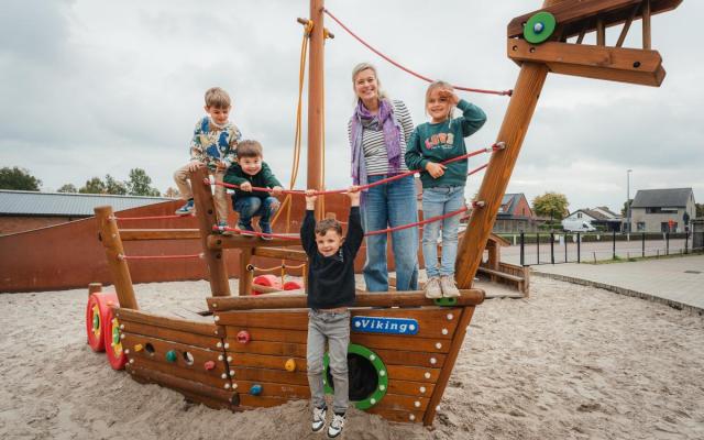Lindsey van Ferm Kinderopvang in Sterbos met een groepje kinderen op een houten speeltuig in de zandbak