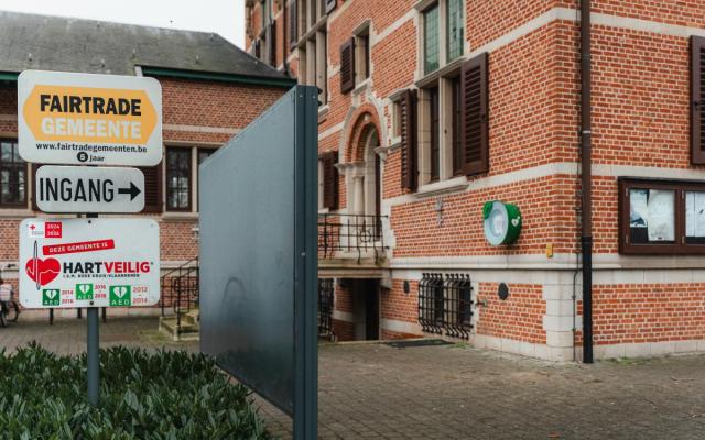 gemeentehuis van Wuustwezel met o.a. het AED-toestel aan de muur en een paneel 'Hartveilige Gemeente'
