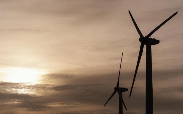 foto van twee windturbines in schemerlicht 