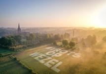 De hashtag #trotsopwezel geprojecteerd in een veld nabij de kerk van Wuustwezel centrum.
