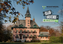 gemeentehuis van Wuustwezel met daarnaast het logo van Baanbrekende Werkgever '25
